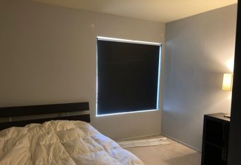 Custom blackout roller shades installed in a Santa Clarita bedroom, providing total light control and privacy.