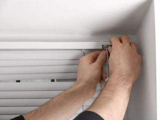 Skilled Technicians Repairing Window Coverings in Santa Clarita A man takes a mesure for blinds installation in Santa Clarita